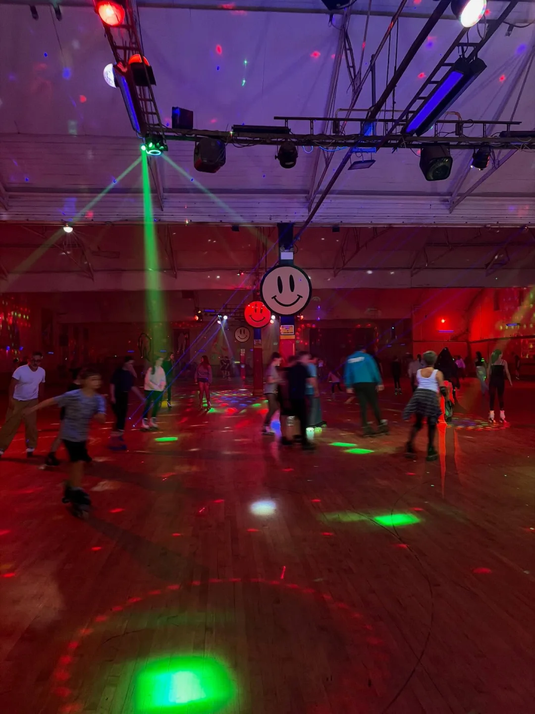 Skaters enjoying a Wigan Roller Rink night under colourful lights
