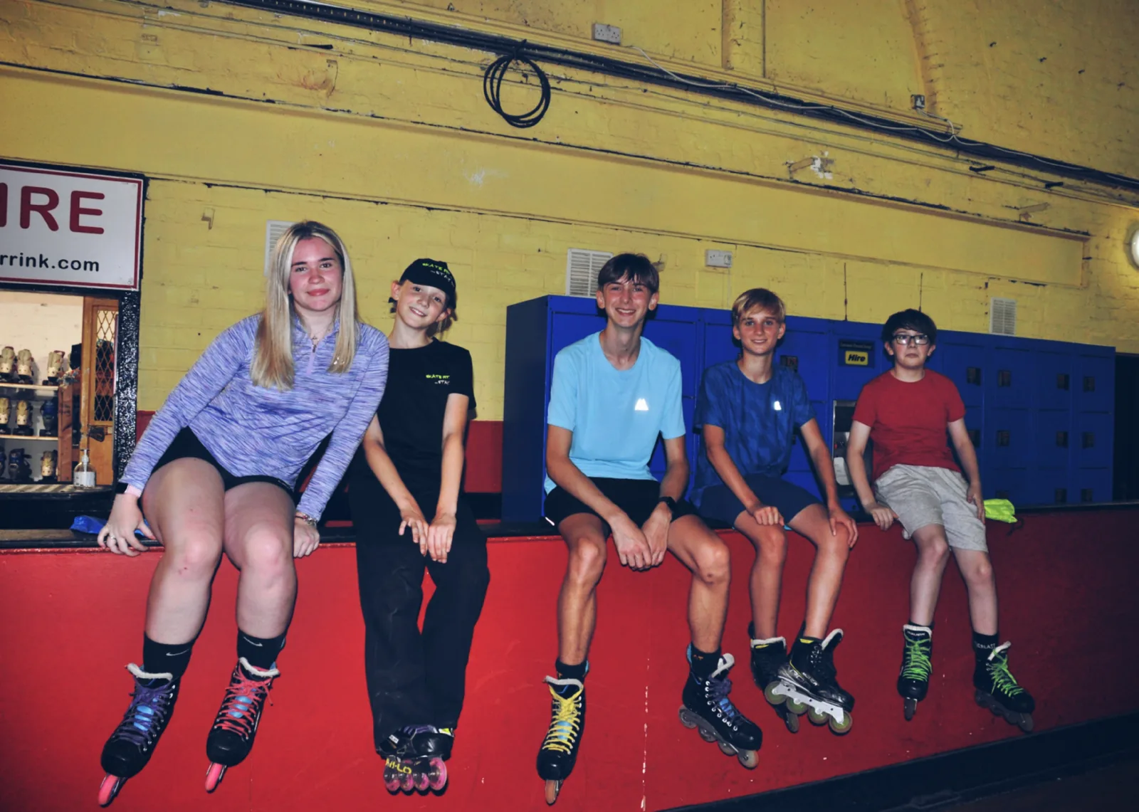 Skate Fit skaters sitting together at Wigan Roller Rink